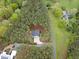 An aerial view depicting the home's secluded location, surrounded by trees and a road at 749 Bowden Rd, Chapel Hill, NC 27516