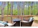 Comfortable back deck with an outdoor table and chair set, surrounded by serene woods at 749 Bowden Rd, Chapel Hill, NC 27516