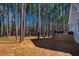 Landscaped backyard featuring mature trees, a deck and outdoor seating at 749 Bowden Rd, Chapel Hill, NC 27516