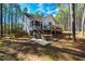 Rear exterior view of the home showcasing its screened porch, deck, and patio with outdoor seating at 749 Bowden Rd, Chapel Hill, NC 27516