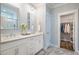 Bright bathroom features a double sink vanity with white cabinets and a walk-in closet at 749 Bowden Rd, Chapel Hill, NC 27516