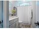 Clean and modern bathroom featuring a gray vanity, white shower curtain, and a soothing, neutral color scheme at 749 Bowden Rd, Chapel Hill, NC 27516