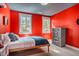 Vibrant bedroom featuring a bright accent wall and abundant natural light at 749 Bowden Rd, Chapel Hill, NC 27516
