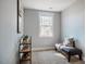 Cozy bedroom space with a large window, carpeted floors, and a stylish decorative bench at 749 Bowden Rd, Chapel Hill, NC 27516