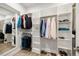 Bright walk-in closet featuring custom shelving, a mirror, and hardwood floors at 749 Bowden Rd, Chapel Hill, NC 27516