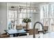 Bright dining room with large windows, stylish light fixture and a table with seating for six at 749 Bowden Rd, Chapel Hill, NC 27516