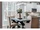 Bright dining room features a modern chandelier and a view of the surrounding woods at 749 Bowden Rd, Chapel Hill, NC 27516