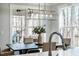 Dining room features a modern light fixture and views of the trees outside the window at 749 Bowden Rd, Chapel Hill, NC 27516