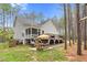 Spacious backyard with a patio, dining set, grill, deck and lush green grass at 749 Bowden Rd, Chapel Hill, NC 27516