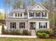 Charming two-story home with stone accents, dark shutters, manicured lawn and professional landscaping at 749 Bowden Rd, Chapel Hill, NC 27516