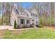 Beautiful two-story home featuring a stone facade, black shutters, manicured lawn and professional landscaping at 749 Bowden Rd, Chapel Hill, NC 27516