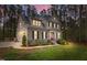 Stunning two-story home with stone accents, black shutters, manicured lawn, and professional landscaping at 749 Bowden Rd, Chapel Hill, NC 27516