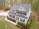 Aerial view of a gracious two-story home with dark shutters and professional landscaping on a large lot at 749 Bowden Rd, Chapel Hill, NC 27516