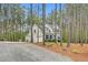 Beautiful two-story home nestled among tall pine trees, featuring stone accents and a spacious three-car garage at 749 Bowden Rd, Chapel Hill, NC 27516