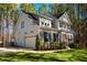 Side view of a two-story home with a two-car garage, basketball hoop, and manicured lawn at 749 Bowden Rd, Chapel Hill, NC 27516