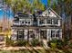 Front exterior view of a two-story home featuring stone accents and a well-maintained lawn at 749 Bowden Rd, Chapel Hill, NC 27516