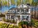 Charming two-story home with stone accents, well-manicured landscaping, and black shutters at 749 Bowden Rd, Chapel Hill, NC 27516
