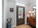 Inviting foyer with an open front door, wood floors, neutral walls, and wood accents at 749 Bowden Rd, Chapel Hill, NC 27516