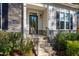 Close-up of the front door and porch, showing stone steps and a beautifully landscaped entrance at 749 Bowden Rd, Chapel Hill, NC 27516