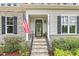 Close-up of the front entrance with stone steps, black railings, and manicured landscaping, creating a welcoming ambiance at 749 Bowden Rd, Chapel Hill, NC 27516