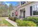 Inviting front porch featuring stone accents, dark shutters and professional landscaping at 749 Bowden Rd, Chapel Hill, NC 27516