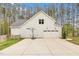 Spacious three-car garage with a basketball hoop and a large concrete driveway, providing ample parking space at 749 Bowden Rd, Chapel Hill, NC 27516