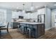 Bright kitchen featuring a large island with seating and stainless steel appliances at 749 Bowden Rd, Chapel Hill, NC 27516