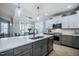 Modern kitchen featuring a large island, stainless steel appliances, and two-toned cabinetry with pendant lighting at 749 Bowden Rd, Chapel Hill, NC 27516