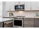 Kitchen featuring stainless steel appliances, white cabinets and quartz countertops at 749 Bowden Rd, Chapel Hill, NC 27516