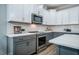 Modern kitchen featuring gray cabinets and stainless steel appliances at 749 Bowden Rd, Chapel Hill, NC 27516
