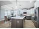 Bright, updated kitchen with stainless steel appliances, a large island, and an adjacent dining area with forest views at 749 Bowden Rd, Chapel Hill, NC 27516