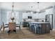 Open kitchen featuring a large island with seating and stainless steel appliances at 749 Bowden Rd, Chapel Hill, NC 27516