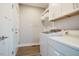 Functional laundry room with cabinets and shelving at 749 Bowden Rd, Chapel Hill, NC 27516