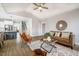 Open concept living area with kitchen view, staircase, modern decor, and lots of light at 749 Bowden Rd, Chapel Hill, NC 27516