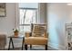 Cozy bedroom nook with an accent chair and a window view of the surrounding wooded landscape at 749 Bowden Rd, Chapel Hill, NC 27516