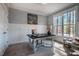 Spacious home office with wainscoting, a vintage desk, and a comfortable sitting area bathed in natural light at 749 Bowden Rd, Chapel Hill, NC 27516