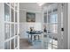 Bright office space with charming French doors, a vintage desk, and soft natural light, perfect for a home workspace at 749 Bowden Rd, Chapel Hill, NC 27516