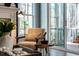 Cozy sitting area with comfortable chair, table, lamp and access to porch at 749 Bowden Rd, Chapel Hill, NC 27516