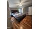 Spacious bedroom featuring wood-look floors, ceiling fan, and ample natural light at 88 Barnes Rd, Middlesex, NC 27557