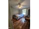 Cozy bedroom featuring hardwood floors, a ceiling fan, neutral walls, and a plaid bedspread at 88 Barnes Rd, Middlesex, NC 27557
