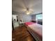 Bright bedroom with two beds, vanity, ceiling fan, and wood-look floors at 88 Barnes Rd, Middlesex, NC 27557
