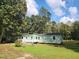 Charming single-story home featuring a painted exterior, white trim, a small deck, and a green lawn at 88 Barnes Rd, Middlesex, NC 27557