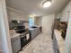 Modern kitchen featuring stainless steel appliances, ample counter space, decorative backsplash, and marble tile floors at 88 Barnes Rd, Middlesex, NC 27557