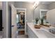 Bright bathroom showcasing a double vanity, a large mirror, modern fixtures, and access to a private office at , Efland, NC 27243
