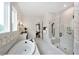 Luxurious bathroom with a soaking tub, frameless glass shower, designer wallpaper, and marble floors at , Efland, NC 27243