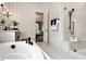 Beautiful bathroom boasting designer wallpaper, a soaking tub, frameless shower, and black matte fixtures at , Efland, NC 27243