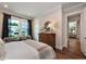 Well-lit bedroom with a modern dresser, plush bedding, stylish curtains, and seamless access to adjacent room at , Efland, NC 27243