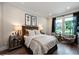 Charming bedroom featuring a decorative accent wall, bedside tables, and an abundance of natural light at , Efland, NC 27243