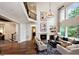 Elegant living room featuring a fireplace, large windows, high ceilings, and stylish decor at , Efland, NC 27243