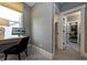 A well-lit home office space with gray walls, a modern desk, and access to other rooms in the house at , Efland, NC 27243